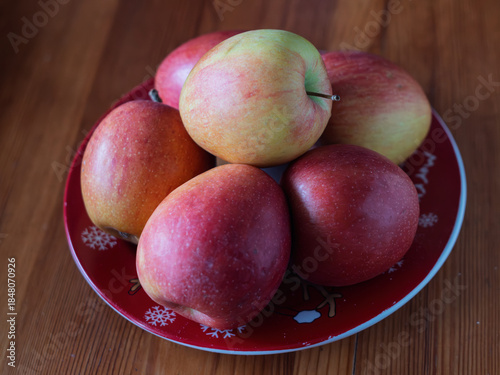 Fresh Red and Green Apples on a Decorative X-Mas Plate
