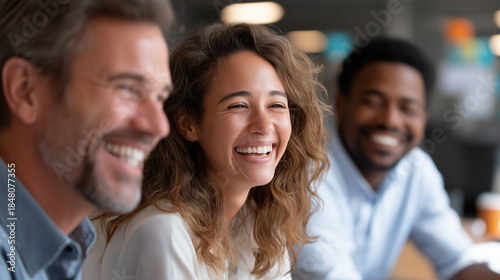 Faceless business colleagues sharing laugh over tablet, male executive and young female employee, defocused workplace humor, professional camaraderie, office bonding moment , with 