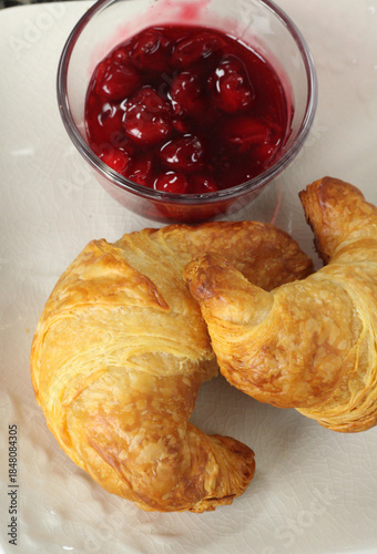 French croissants served with cherry preserves.