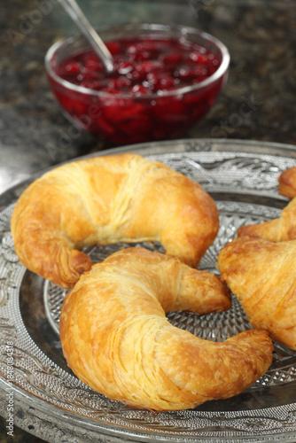 French croissants served with cherry preserves.