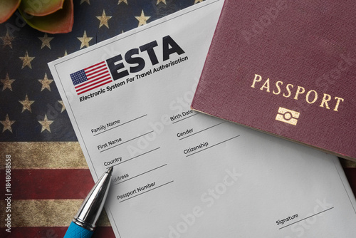 Esta application form with passport and pen on american flag background