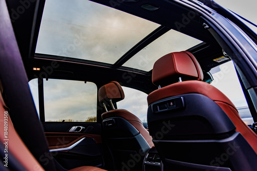 Konstfotografi Luxury car interior with red leather seats and sunroof