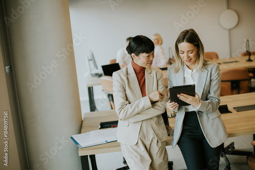 Two women discuss a project...