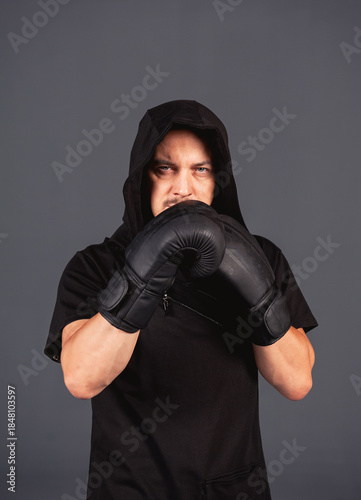 Boxing fighter man wearing black hood stance portrait