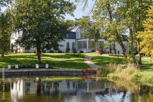 Neeruti Manor park path and pond reflection Estonia