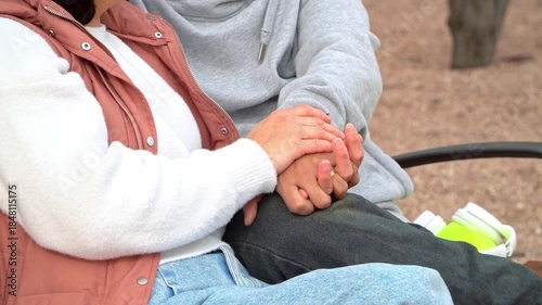 Married couple holding hands showing wedding rings on a romantic date