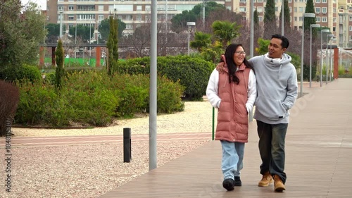 Multiethnic couple on a romantic walk together on the park on Valentine’s Day
