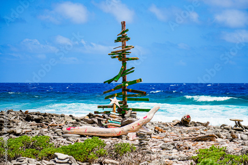 Handmade christmas tree sculpture made of driftwood on the rugged coast of Lacre Punt, the southern tip of Bonaire island in the Dutch Caribbean