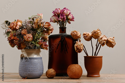 A quiet still life featuring dried floral arrangements