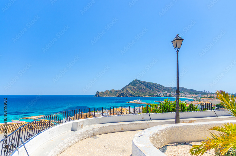 Fototapeta premium Altea old town aerial view with typical white houses buildings, Altea bay Mediterranean Sea azure water, mountain Sierra Helada park, Altea city centre, Alicante province, Valencian Community, Spain