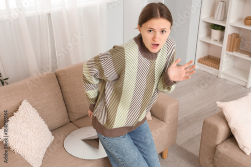 Shocked young woman with he...