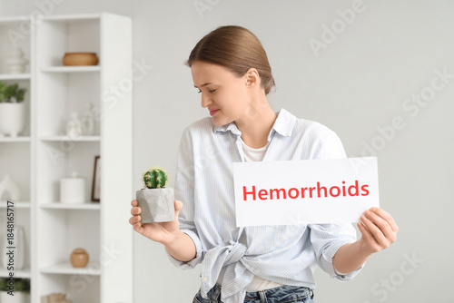 Young woman holding paper w...