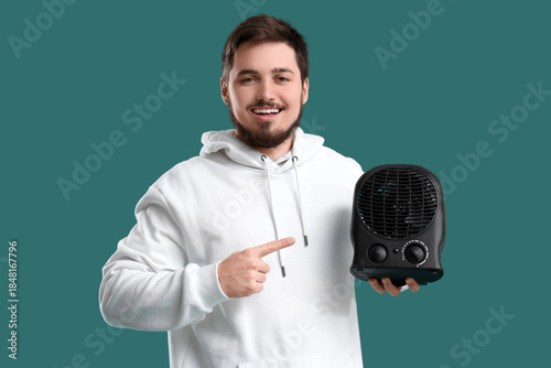 Young man pointing at black...