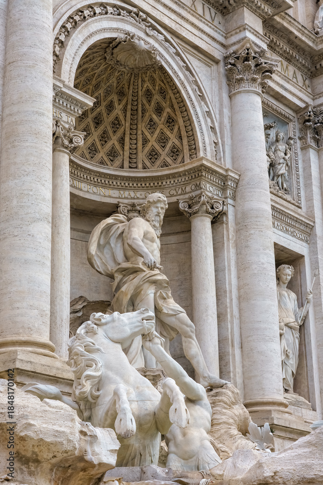 Fototapeta premium Rome, Italy. Detail of the Trevi Fountain featuring marble statues, sculpted rocks, and dynamic Baroque figures carved in white stone.