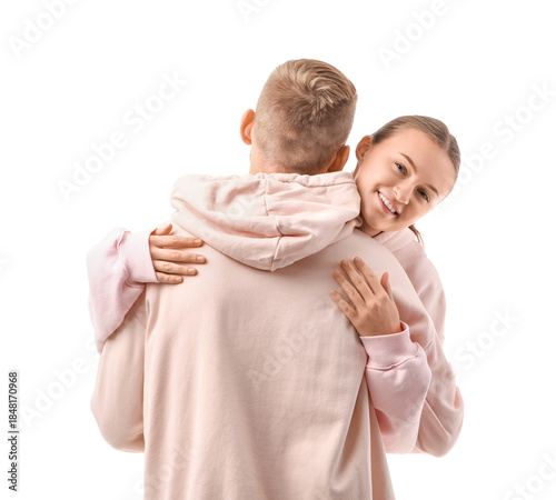 Young couple in hoodies hug...