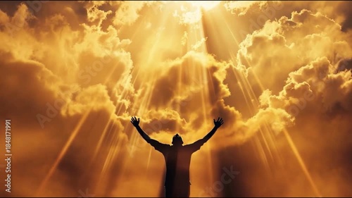 A silhouetted human figure standing with arms raised toward the sky, illuminated by powerful heavenly light rays. Concept of faith, belief in God, prayer, spirituality, divine connection, hope, surren