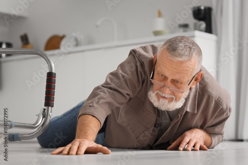 Senior man lying on floor a...