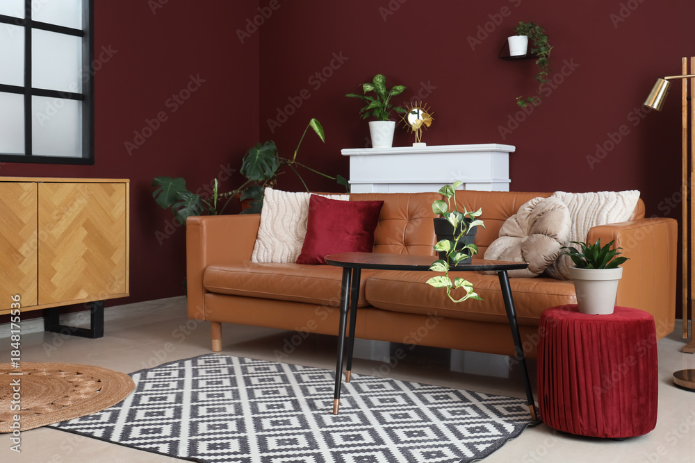 Fototapeta premium Interior of modern living room with cozy brown sofa, coffee table, ottoman and fireplace