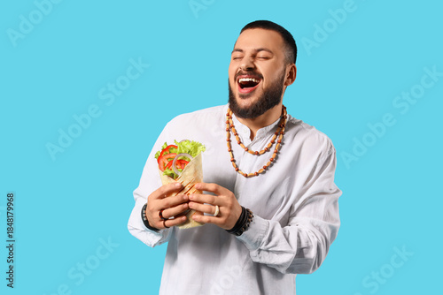 Happy young Muslim man with...