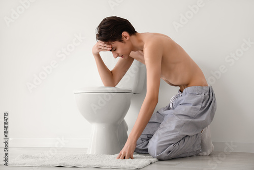 Young man with anorexia sit...