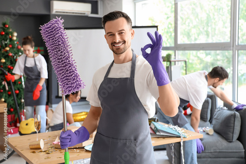 Male janitor with mop showi...