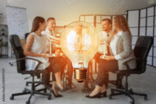Glowing light bulb and busi...