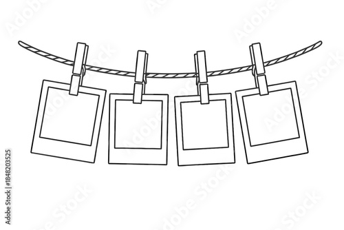 Four blank instant photo frames hanging from a clothesline with clips