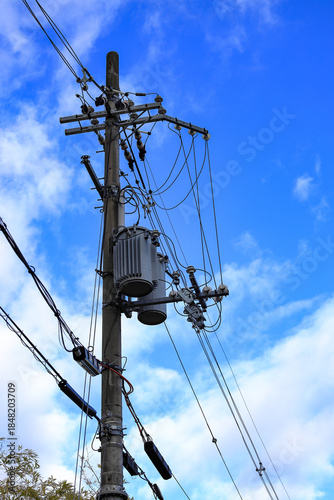 AC high-voltage power transformer, Electrical Transformer and High voltage power lines installed on electric pole.