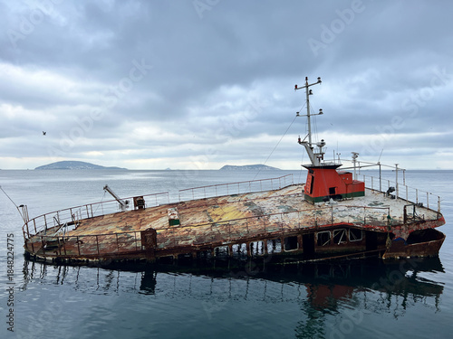 Partially sunken and rusted ship
