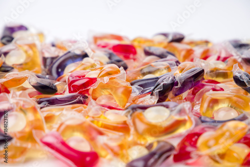 Background of multicolored washing gel capsules. Selective focus.