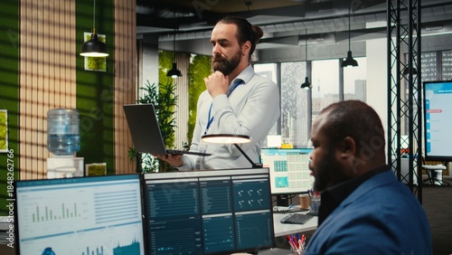 Quadro em tela Office administrator completing daily tasks and monitoring work efficiency, utilizing data insights on infographics to generate performance reports and statements for management solutions