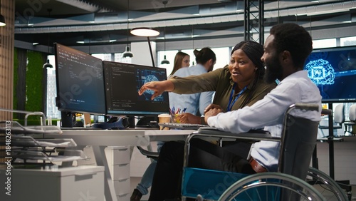Canvas Print Smiling startup engineer and colleague with disability brainstorming, using machine learning tech