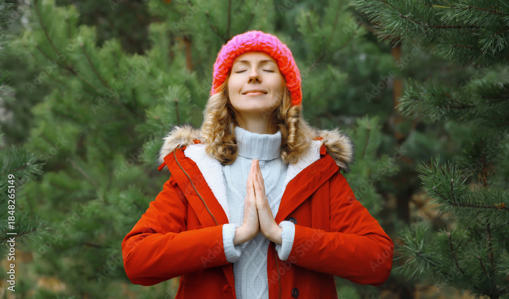 © rohappy - Calm relaxed healthy woman meditates in winter forest, girl practicing doing yoga exercises outdoors