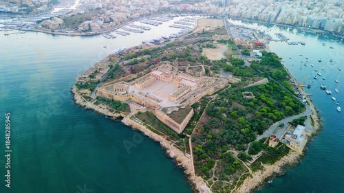 Aerial drone view of Fort Manoel on Manoel Island, Malta. Star-shaped military fortress in Marsamxett Harbour with Valletta city views.
