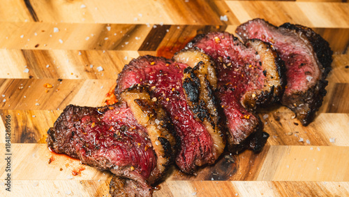 Konstfotografi Sliced rare beef brisket on a wooden board, with a toasted crust and pink interior