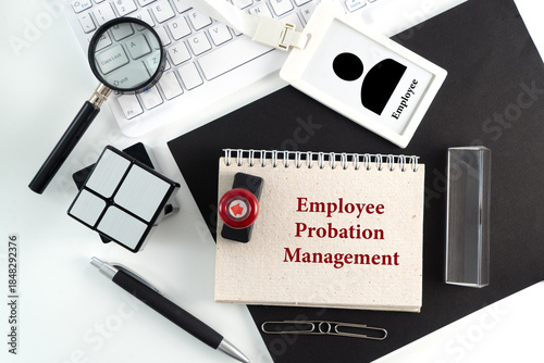Obraz na plátne Employee Probation Management Document with Office Supplies and ID Badge