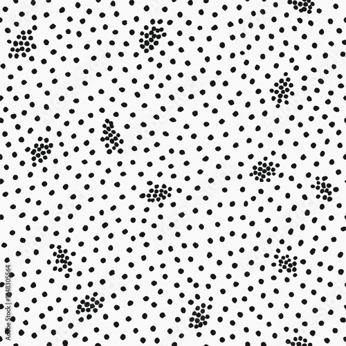Repeating pattern of scattered small black dots and clusters of dots on white circles black and white