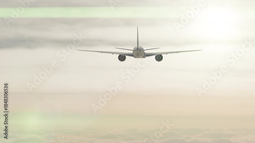 Passenger Airplane Above the Clouds Flying Off Into A Beautiful Sunset.