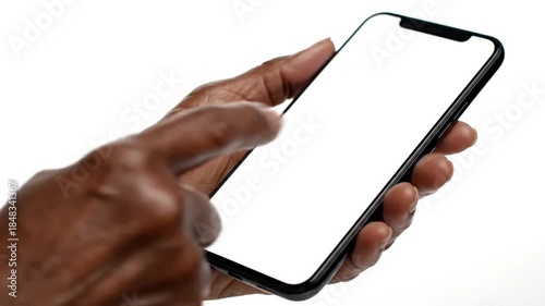 Isolated close-up: an adult hand holds a modern smartphone with a blank white screen against a white background. Offers ideal copy space for app mockups, tech ads, demonstrating digital connectivity o