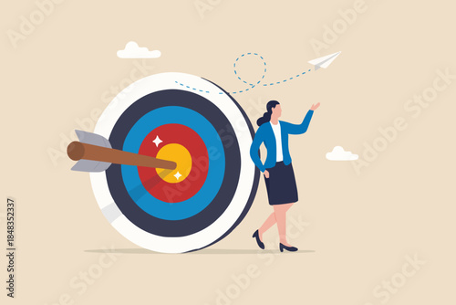 Business objective, purpose or target, goal and resolution to aim for success, aspiration and motivation to achieve goal concept, confident businessman stand with arrow hit bullseye on archery target.