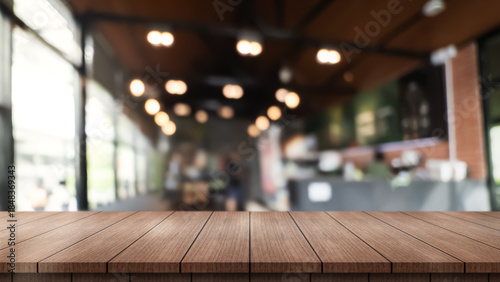 Empty wooden table top with lights bokeh on blur restaurant background.
