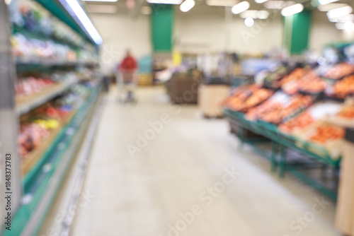Wallpaper Mural Blurred interior of a grocery store aisle with shoppers and fresh produce display. Torontodigital.ca
