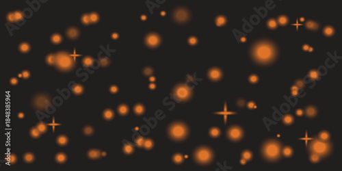 Blurry orange lights on a dark background with star like effects