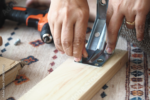 Wallpaper Mural Hands work on metal bracket installation for wood piece Torontodigital.ca
