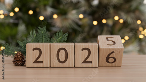 2026 new year countdown wooden blocks calendar and pinecone on counter table across Christmas tree.