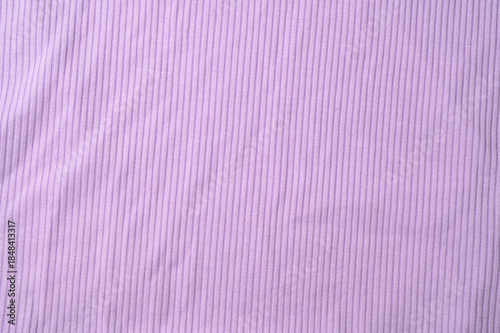 Purple fold knitted fabric background and texture.The fabric features a prominent vertical rib texture.