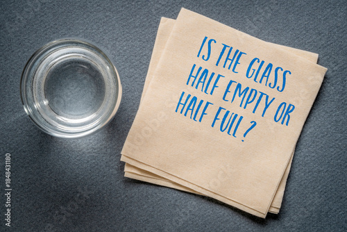 Schilderij op canvas Is the glass half empty or half full? a metaphor for how individuals interpret the same facts in fundamentally different ways