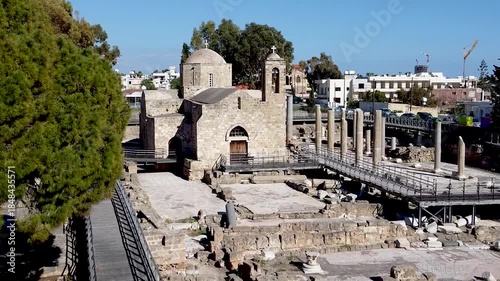Ancient ruins are shown in Paphos, Cyprus with well-preserved structures and remnants of columns. Visitors can enjoy the tranquil atmosphere and scenic views of the surrounding area.