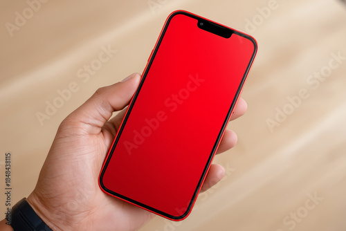 Vibrant red screen mobile phone held in hand ready for product display mockups