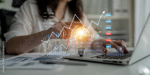 Bilde på lerret A business professional engages with financial data on a laptop, surrounded by innovative graphs and charts that signify growth and success in a corporate environment